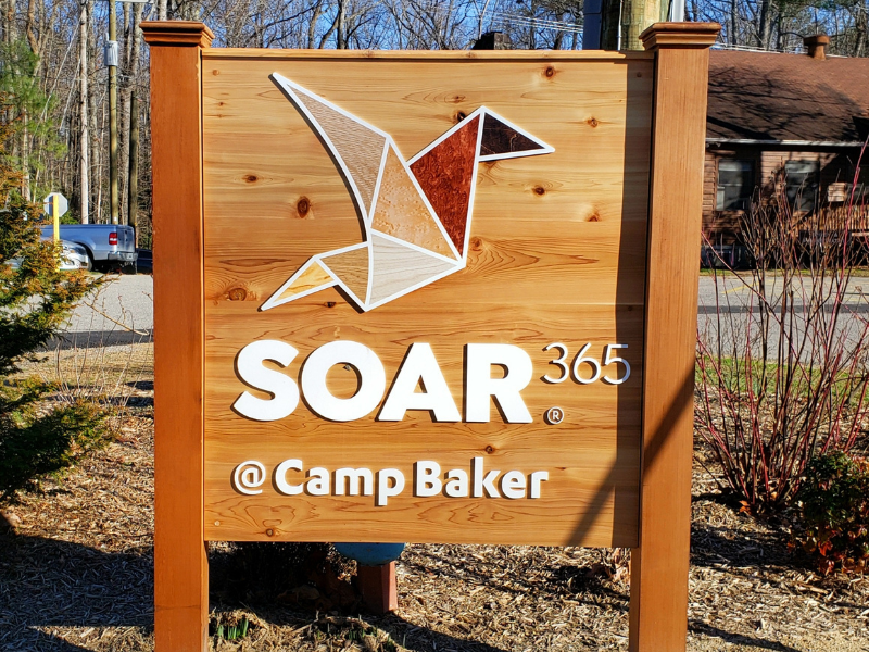 SOAR365's wooden Camp Baker sign sits front and center.