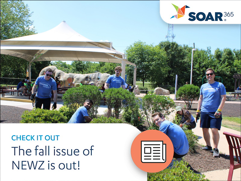 A group of volunteers improving an outdoor space, some smiling at the camera, all in the matching shirts. A text overlay reads, "The fall issue of NEWZ is out!"